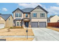 Charming two-story home with a manicured lawn and a two-car garage at 6188 Riddle Ct, Douglasville, GA 30134
