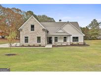 Charming two-story home with mixed siding, brick accents and a well manicured lawn at 110 Warren Way, Fayetteville, GA 30215