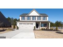 Charming two-story home featuring a two-car garage and a well-manicured lawn at 541 Daffodil Ln, Mcdonough, GA 30253