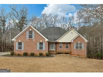 Charming brick home featuring a well-maintained lawn and inviting front porch at 160 Vinnys Way, Covington, GA 30014