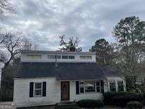 Charming single-Gathering home with a unique design, black shutters, and a well-kept front yard at 1867 Dresden Dr, Atlanta, GA 30319