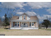 Charming front exterior featuring a welcoming porch and landscaped yard at 1269 Snapping Shoals Rd, Mcdonough, GA 30252