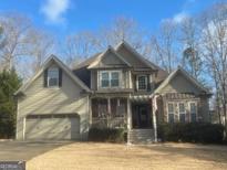 Charming two-story home with attached two-car garage and covered porch entrance at 306 Oakwind Way, Canton, GA 30114