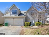Charming two-story home with a two-car garage and well-maintained front yard landscaping at 2903 Ward Lake Way, Ellenwood, GA 30294