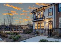 Charming townhome boasts a balcony and fenced front yard, perfect for outdoor living at 300 Olmstead Way, Alpharetta, GA 30022