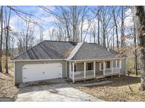 Charming single-Gathering home featuring a welcoming front porch and attached two-car garage at 1602 River Glen Rd, Auburn, GA 30011