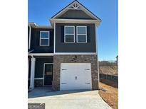 New two-story home featuring a two-car garage, brick accents, and modern architectural details at 111 Meadowview Dr # 21, Temple, GA 30179