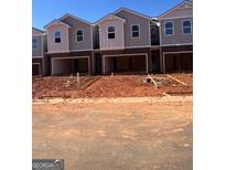 New construction townhomes feature attached garages and modern design elements at 11565 Kimberly Way # 24, Hampton, GA 30228