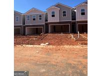 New townhome construction featuring brick accents, modern design, and a visible garage at 11563 Kimberly Way # 23, Hampton, GA 30228