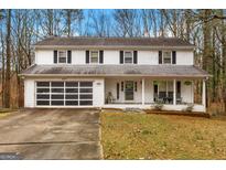Charming two-story home featuring a welcoming front porch and a convenient two-car garage at 1917 Lake Ridge Ct, Jonesboro, GA 30236