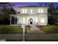 Charming two-story home featuring a welcoming front porch and beautifully landscaped front yard at 76 College St, Mcdonough, GA 30253