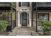 Inviting entrance with black trimmed windows, railings, and door with the building number displayed above it at 3529 Essex Ave # 75, Atlanta, GA 30339