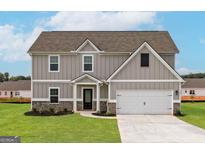 Charming two-story home with gray siding, brick accents, and a two-car garage at 1037 Claas Way, Locust Grove, GA 30248