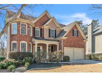 Traditional brick home with attached two-car garage and professionally landscaped front yard at 1654 Summersweet Ln, Dacula, GA 30019