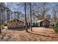 Charming stone-accented home with mature trees and beautiful landscaping in a desirable neighborhood at 825 Sugar Creek Se Way, Conyers, GA 30094