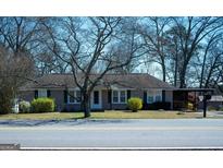 Charming single-story home with a cozy front yard and covered carport at 123 Cowan Rd, Covington, GA 30016