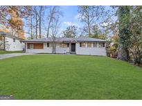 Charming single-story home with a well-manicured lawn and inviting curb appeal at 2378 Green Forrest Dr, Decatur, GA 30032