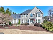 Charming two-story home with well-manicured front yard and inviting entrance at 4569 Chatsworth Ovrlk Ne, Roswell, GA 30075