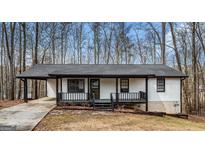 Charming single-story home with a black framed porch and a modern black roof at 1436 Heritage Ct, Villa Rica, GA 30180