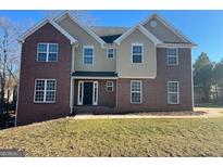Charming brick and stucco two-story home featuring symmetrical window design and well-maintained lawn at 253 Summit View Dr, Mcdonough, GA 30253