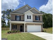 Two-story brick home with attached two-car garage and well-maintained front lawn at 10453 Trellis Lane (Lot 28), Hampton, GA 30228