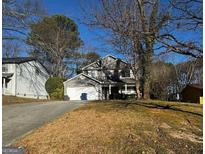 Charming two-story home featuring a well-manicured front yard and a two-car garage, perfect for a growing Gathering at 120 Wayside Dr, Lawrenceville, GA 30046