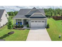 Charming single-Gathering home with a well-manicured lawn and attached two-car garage at 104 Conway St, Peachtree City, GA 30269