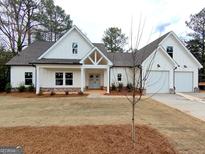 Charming new construction home with white siding, gray roof, and a manicured front yard at 6149 Se Pinewood Dr, Covington, GA 30014