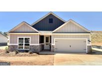 Charming home features a two-car garage and a beautifully designed gray exterior, enhancing its curb appeal at 435 Cantrell Drive, Dallas, GA 30157