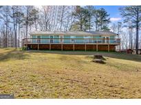 Charming raised ranch with a spacious deck, set on a picturesque lot with mature trees at 4864 Yeagar Rd, Douglasville, GA 30135