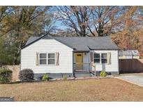 Charming single-story home with shuttered windows and a bright yellow front door at 2114 Fellowship Rd, Tucker, GA 30084