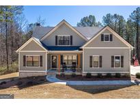 Charming craftsman-style home featuring a covered front porch with rocking chairs and a landscaped front yard at 624 Bexley Rd, Moreland, GA 30259