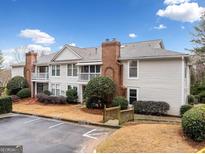 Charming townhouse featuring a brick chimney, exterior balcony, and designated parking at 1379 Keys Lake Ne Dr, Brookhaven, GA 30319