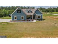 Charming two-story home with blue siding, black shutters, and a landscaped front yard at 296 Beavers Rd, Grantville, GA 30220