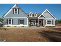 Charming single-Gathering home with blue siding, black shutters, and inviting front porch at 296 Beavers Rd, Grantville, GA 30220