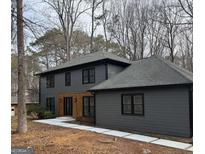 Charming gray two-story home featuring a modern wood accent entryway and walkway at 125 Marilyn Ct, Fayetteville, GA 30214