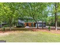 Charming two-story home with a well-manicured lawn and mature trees at 125 Marilyn Ct, Fayetteville, GA 30214