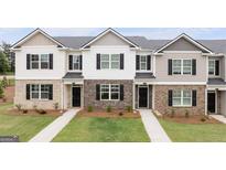 Attractive new townhomes featuring varied exteriors, well maintained lawns, and inviting front entrances at 436 Reflection Drive # 15, Stockbridge, GA 30281