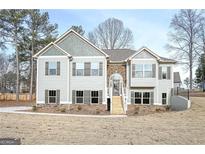 Charming two-story home with stone accents and a welcoming front porch, perfect for enjoying the outdoors at 5995 Crowley Dr, Douglasville, GA 30135