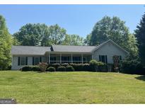 Charming single-story home featuring a welcoming front porch and well-maintained landscaping at 6365 Mountain View Trl, Cumming, GA 30041