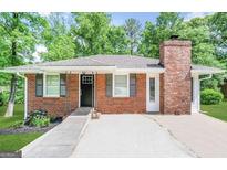 Charming brick home featuring gray shutters and a chimney at 9184 Thrash Sw St, Covington, GA 30014