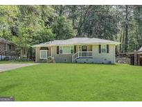 Charming single-story home featuring a well-manicured lawn and inviting front porch at 1908 S Columbia Pl, Decatur, GA 30032