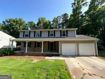 Charming two-story home with a welcoming front porch and a two car garage at 2691 Old South Dr, Jonesboro, GA 30236