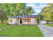 Charming home with a well-manicured lawn, complemented by modern shutter details at 230 Argus Cir, Atlanta, GA 30331