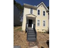 Charming two-story home featuring a welcoming front porch and well-maintained yard at 4049 Heritage Valley Ct, Norcross, GA 30093