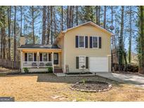 Charming two-story home with a well-manicured lawn and cozy front porch at 104 Sage Blue, Peachtree City, GA 30269