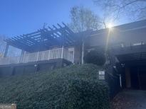 Features a charming home exterior with a covered patio and lush greenery enhancing curb appeal at 294 Hascall Nw Rd, Atlanta, GA 30309