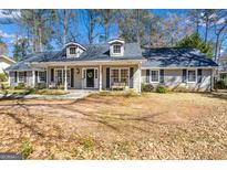 Charming one-story home featuring dormer windows and a welcoming front porch at 105 Roundleaf Ct, Peachtree City, GA 30269