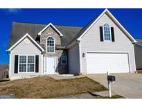 Charming two-story home features a two-car garage and stone accents at 4907 Buchli Ln, Lithonia, GA 30038