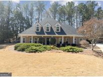 Charming single-Gathering home featuring dormer windows and manicured landscaping at 2407 Honey Ct, Mcdonough, GA 30252